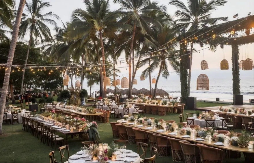 Corporate event long tables under palms